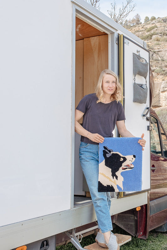 Tufting rugs in a small van studio – Emmi's creative van life setup.